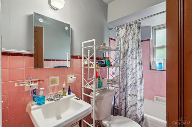 3366 Wunder Ave, Cincinnati, OH 45211 - full bathroom with shower / tub combo, a sink, toilet, tile walls, and wainscoting