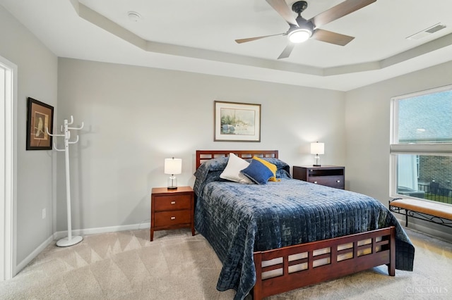 5014 S Castle Ct, Liberty Twp, OH 45011 - bedroom featuring a tray ceiling, light carpet, baseboards, and ceiling fan
