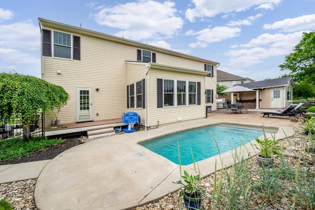 1171 Craig Ct, Hamilton Twp, OH 45039 - view of swimming pool featuring a wooden deck, a patio, and an outdoor structure