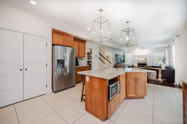 1171 Craig Ct, Hamilton Twp, OH 45039 - kitchen with stainless steel appliances, open floor plan, a ceiling fan, light tile patterned flooring, and a center island