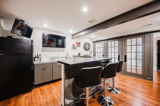 1171 Craig Ct, Hamilton Twp, OH 45039 - bar area with freestanding refrigerator, light wood-style flooring, recessed lighting, and backsplash