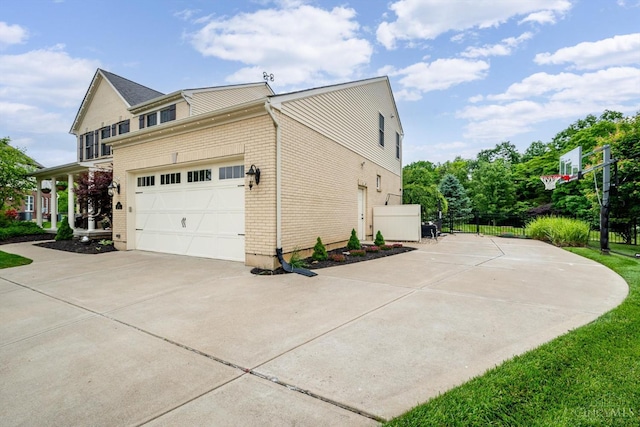 1171 Craig Ct, Hamilton Twp, OH 45039 - view of home's exterior featuring driveway, brick siding, and a garage