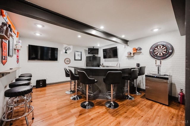 1171 Craig Ct, Hamilton Twp, OH 45039 - indoor wet bar featuring freestanding refrigerator, light wood-style flooring, brick wall, beam ceiling, and recessed lighting