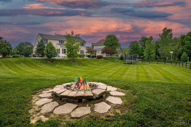 1171 Craig Ct, Hamilton Twp, OH 45039 - yard at dusk with a trampoline and a fire pit