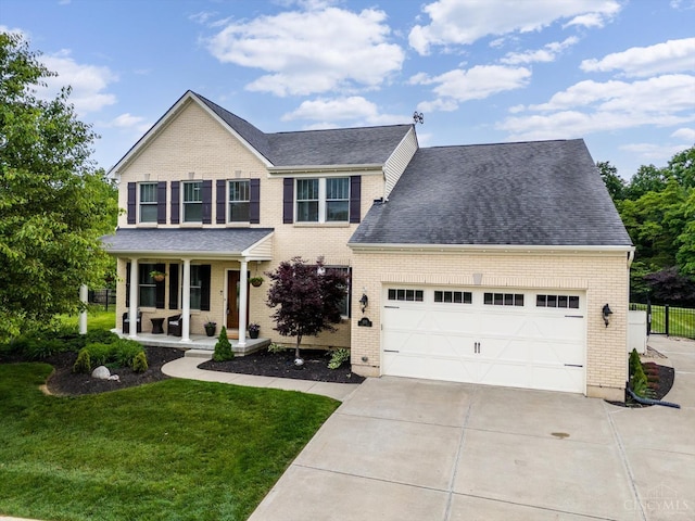 1171 Craig Ct, Hamilton Twp, OH 45039 - traditional-style house with covered porch, an attached garage, driveway, brick siding, and roof with shingles