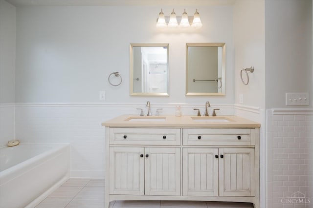 1171 Craig Ct, Hamilton Twp, OH 45039 - full bath featuring a wainscoted wall, double vanity, a garden tub, tile walls, and tile patterned floors