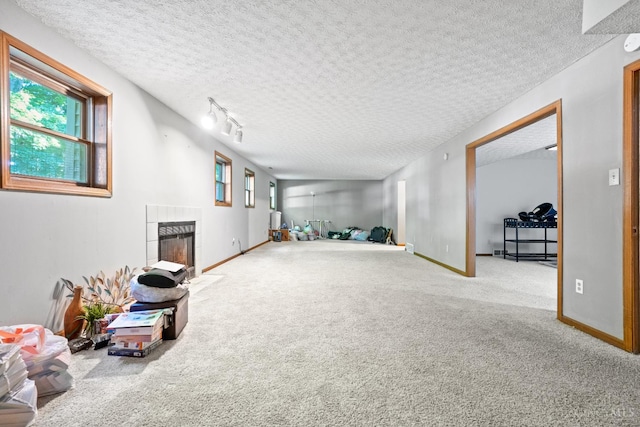2020 Woodcreek Dr, Fairfield, OH 45014 - interior space with a tile fireplace, carpet floors, a textured ceiling, and healthy amount of natural light