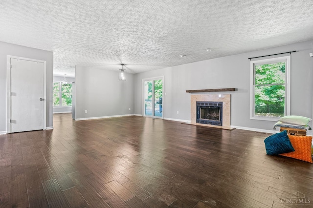 2020 Woodcreek Dr, Fairfield, OH 45014 - unfurnished living room featuring hardwood / wood-style flooring, a fireplace, baseboards, a textured ceiling, and a chandelier