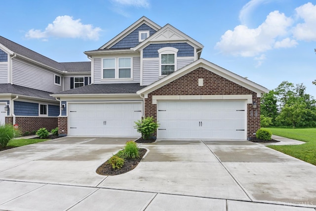 1387 Lake Run Dr, Turtle Creek Twp, OH 45036 - view of front facade featuring brick siding, driveway, and an attached garage