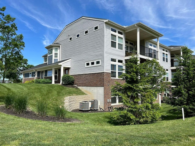 1387 Lake Run Dr, Turtle Creek Twp, OH 45036 - view of home's exterior featuring central AC, a lawn, and brick siding
