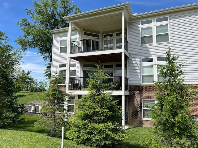 1387 Lake Run Dr, Turtle Creek Twp, OH 45036 - view of front facade with a balcony, brick siding, and a front yard