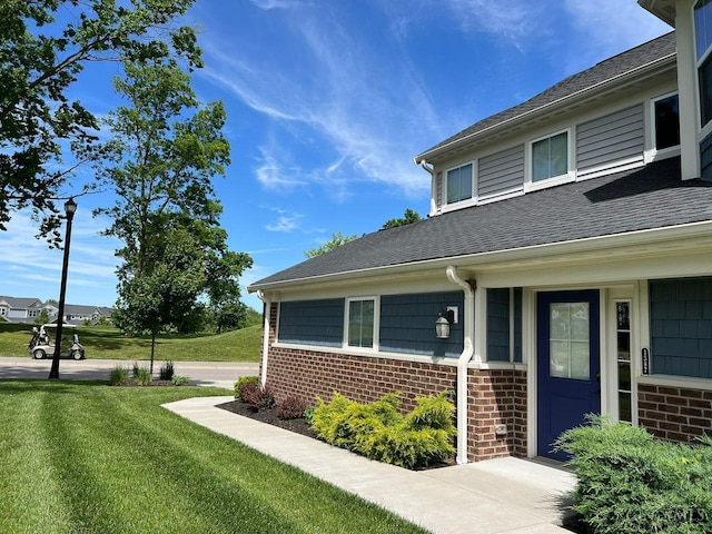 1387 Lake Run Dr, Turtle Creek Twp, OH 45036 - view of side of home featuring brick siding, roof with shingles, and a yard