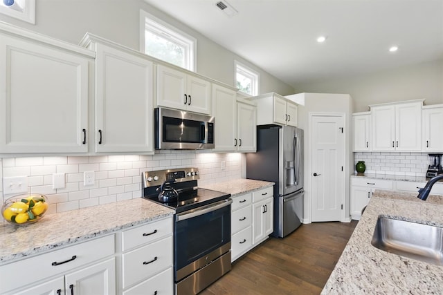 1387 Lake Run Dr, Turtle Creek Twp, OH 45036 - kitchen with appliances with stainless steel finishes, a sink, white cabinets, dark wood-style floors, and recessed lighting