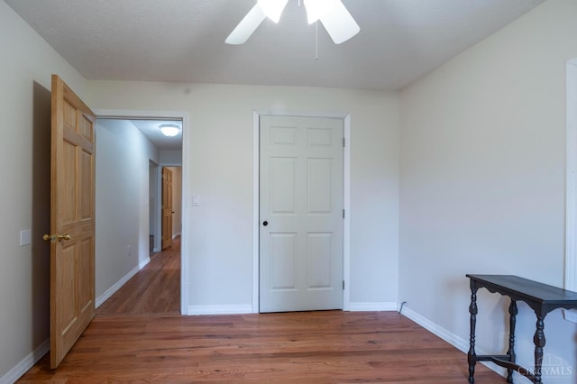 1182 Hook Morgan Rd, Concord Twp, OH 45679 - unfurnished bedroom with wood finished floors, baseboards, and ceiling fan
