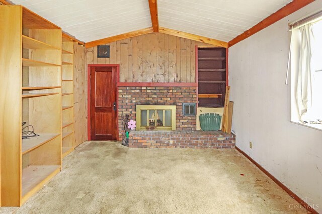 738 Clough Pike, Union Twp, OH 45245 - unfurnished living room featuring lofted ceiling, a brick fireplace, carpet floors, and wood walls