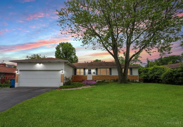 738 Clough Pike, Union Twp, OH 45245 - ranch-style home with driveway, a front lawn, an attached garage, and brick siding
