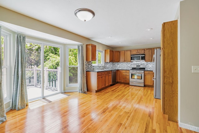 4600 Blainfield Ct, Union Twp, OH 45103 - kitchen with appliances with stainless steel finishes, light wood finished floors, tasteful backsplash, and brown cabinetry
