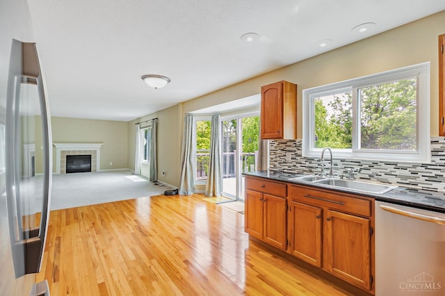4600 Blainfield Ct, Union Twp, OH 45103 - kitchen featuring appliances with stainless steel finishes, a sink, light wood-style floors, dark countertops, and backsplash