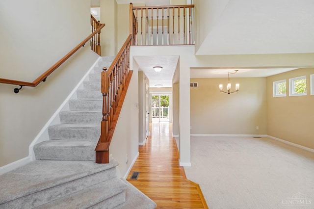 4600 Blainfield Ct, Union Twp, OH 45103 - staircase with plenty of natural light, a chandelier, baseboards, and wood finished floors