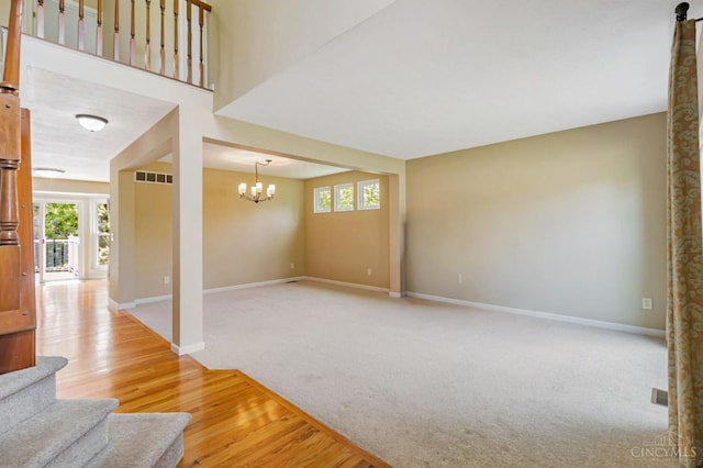 4600 Blainfield Ct, Union Twp, OH 45103 - unfurnished living room with baseboards, a chandelier, plenty of natural light, and wood finished floors