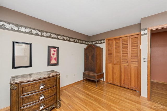 9488 Daugherty Marks Rd, Clark Twp, OH 45130 - bedroom featuring light wood-style flooring, baseboards, and a closet