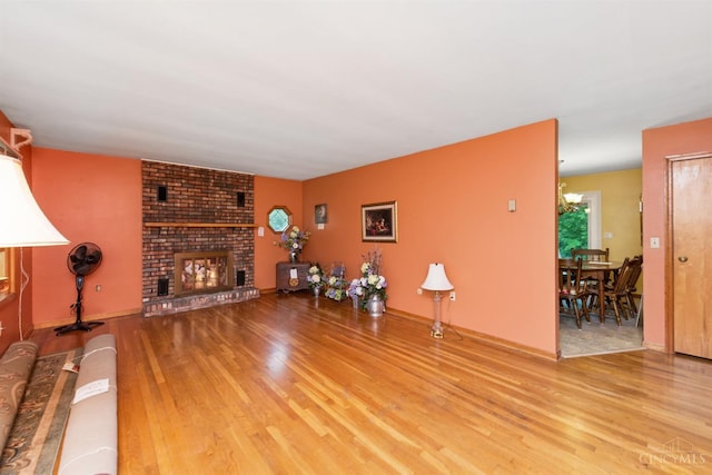 9488 Daugherty Marks Rd, Clark Twp, OH 45130 - living area with wood finished floors, a brick fireplace, and baseboards