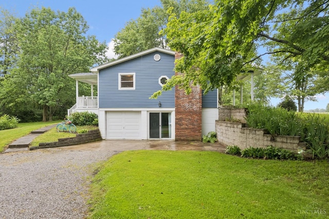 9488 Daugherty Marks Rd, Clark Twp, OH 45130 - view of front facade with asphalt driveway, a front yard, and a garage