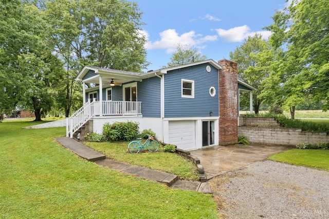 9488 Daugherty Marks Rd, Clark Twp, OH 45130 - single story home with a porch, a front yard, concrete driveway, an attached garage, and a ceiling fan
