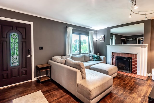 5411 Lester Rd, Cincinnati, OH 45213 - living area with wood finished floors, a brick fireplace, crown molding, and baseboards