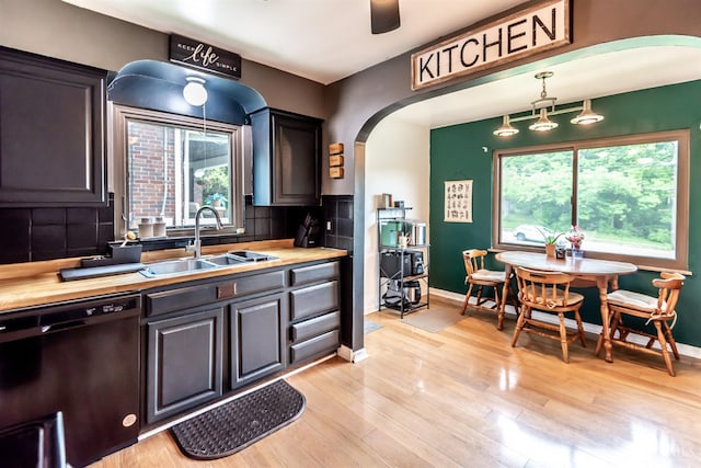 5411 Lester Rd, Cincinnati, OH 45213 - kitchen with a sink, black dishwasher, arched walkways, and healthy amount of natural light