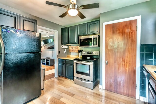 5411 Lester Rd, Cincinnati, OH 45213 - kitchen featuring appliances with stainless steel finishes, light wood-style floors, ceiling fan, and light countertops