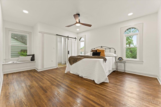 3970 Abington Ave, Cincinnati, OH 45229 - bedroom with multiple windows, a barn door, wood finished floors, and recessed lighting