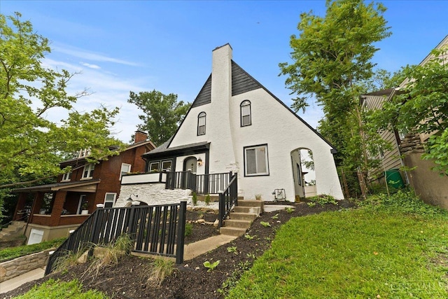 3970 Abington Ave, Cincinnati, OH 45229 - rear view of house featuring a chimney, stucco siding, and a porch