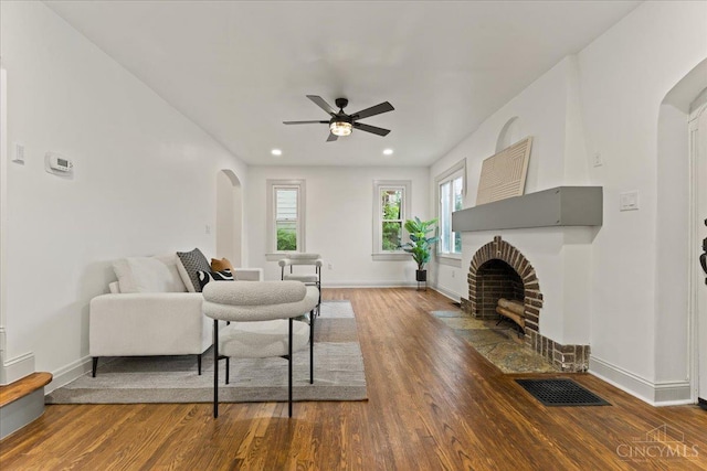 3970 Abington Ave, Cincinnati, OH 45229 - living room featuring arched walkways, wood finished floors, ceiling fan, a fireplace, and recessed lighting