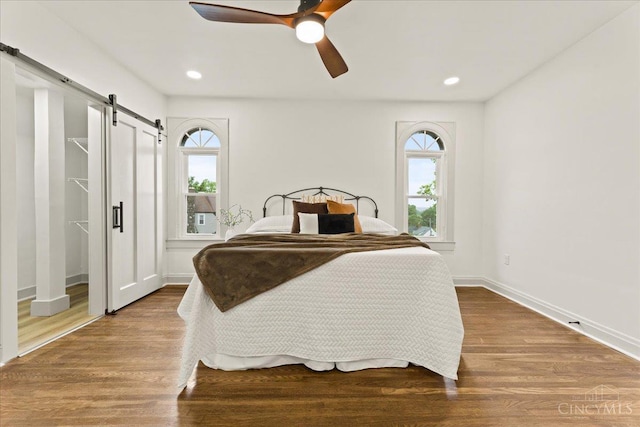 3970 Abington Ave, Cincinnati, OH 45229 - bedroom with a barn door, wood finished floors, ceiling fan, and recessed lighting