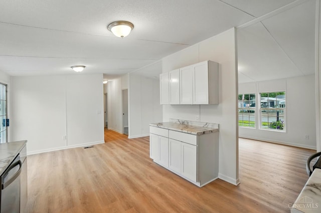 665 Diamond Loop, Middletown, OH 45044 - kitchen featuring stainless steel dishwasher, light wood-style floors, light countertops, and open floor plan