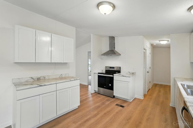 665 Diamond Loop, Middletown, OH 45044 - kitchen with stainless steel appliances, wall chimney exhaust hood, light wood-type flooring, and white cabinets