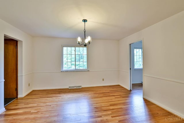 1885 Forest View Ct, Green Twp, OH 45233 - empty room featuring light wood-type flooring, a chandelier, and baseboards