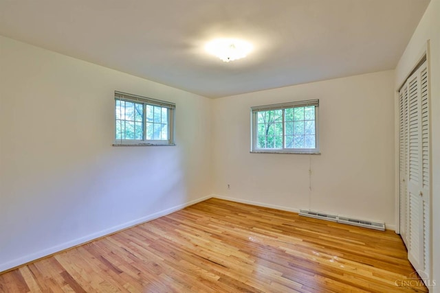 1885 Forest View Ct, Green Twp, OH 45233 - unfurnished bedroom with light wood-style flooring, multiple windows, and baseboards