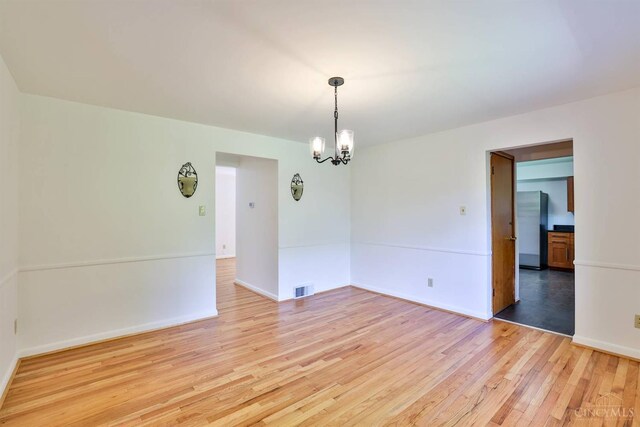 1885 Forest View Ct, Green Twp, OH 45233 - empty room with light wood-type flooring, a chandelier, and baseboards