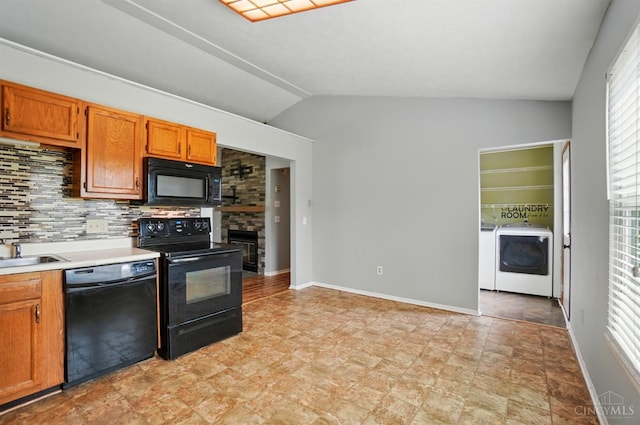 3914 Brookville Dr, Batavia Twp, OH 45102 - kitchen featuring black appliances, washer and dryer, lofted ceiling, decorative backsplash, and light countertops
