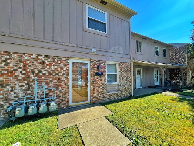 3610 Roosevelt Blvd Unit B, Middletown, OH 45044 - back of house with brick siding, a yard, and board and batten siding