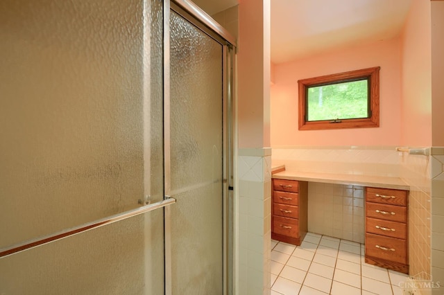 973 Umblebee Rd, Liberty Twp, OH 45613 - bathroom with tile walls, tile patterned flooring, a shower stall, vanity, and a wainscoted wall