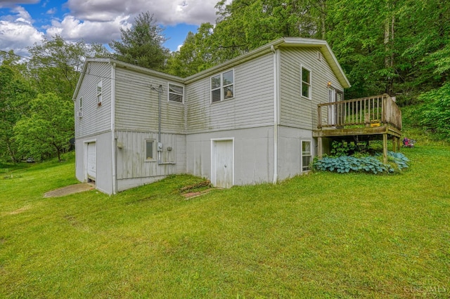 973 Umblebee Rd, Liberty Twp, OH 45613 - rear view of property with a wooden deck, a yard, and an attached garage