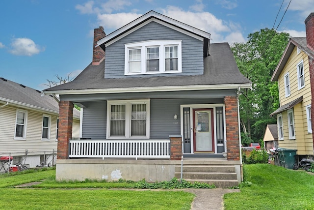 1917 Webman Ct, Cincinnati, OH 45223 - bungalow featuring a porch, a front lawn, and a chimney