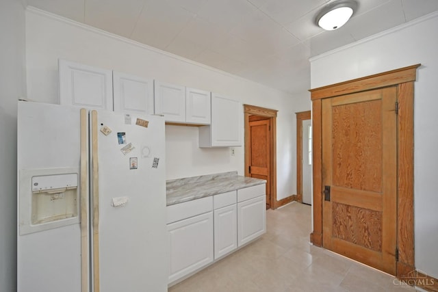 1917 Webman Ct, Cincinnati, OH 45223 - kitchen with white fridge with ice dispenser, white cabinets, light countertops, and ornamental molding