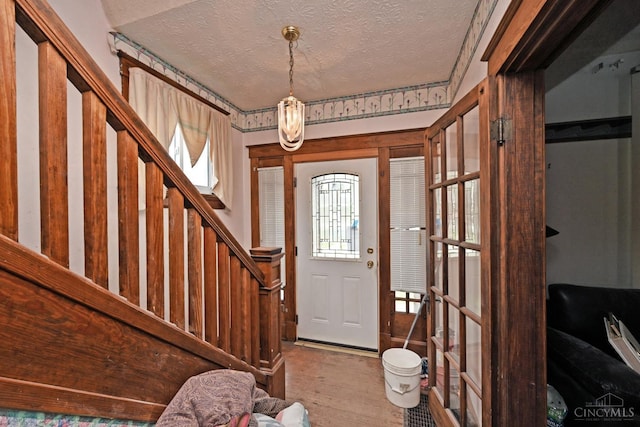 1917 Webman Ct, Cincinnati, OH 45223 - foyer entrance with a textured ceiling, wood finished floors, and stairway