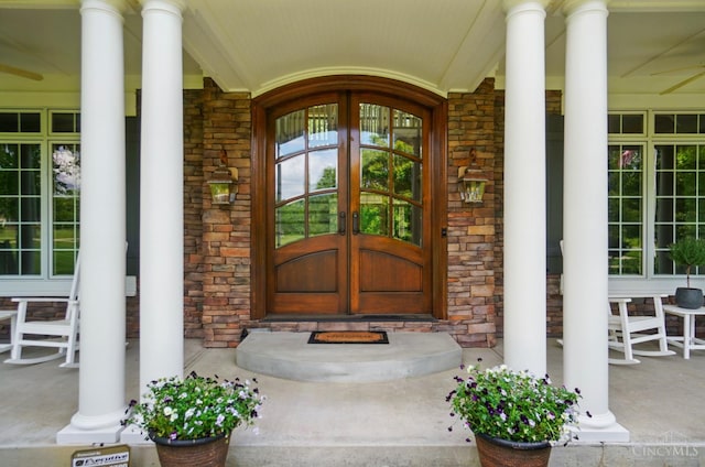 7757 Misty Meadows Ct, Harlan Twp, OH 45152 - doorway to property featuring a porch, stone siding, and french doors