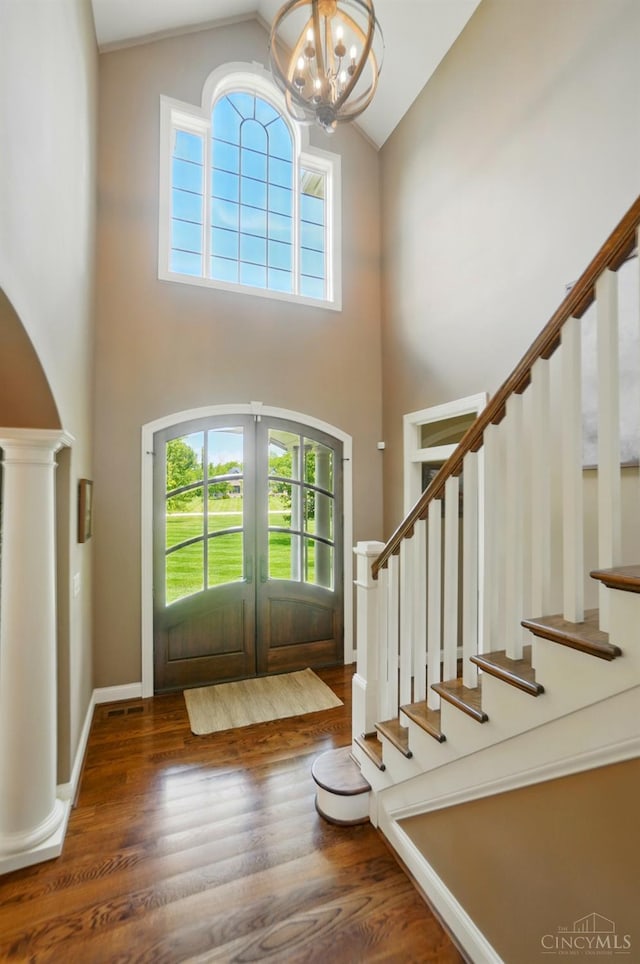 7757 Misty Meadows Ct, Harlan Twp, OH 45152 - entryway featuring high vaulted ceiling, stairs, wood finished floors, a chandelier, and french doors