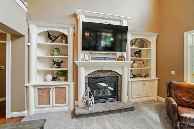7757 Misty Meadows Ct, Harlan Twp, OH 45152 - carpeted living area featuring a stone fireplace and baseboards